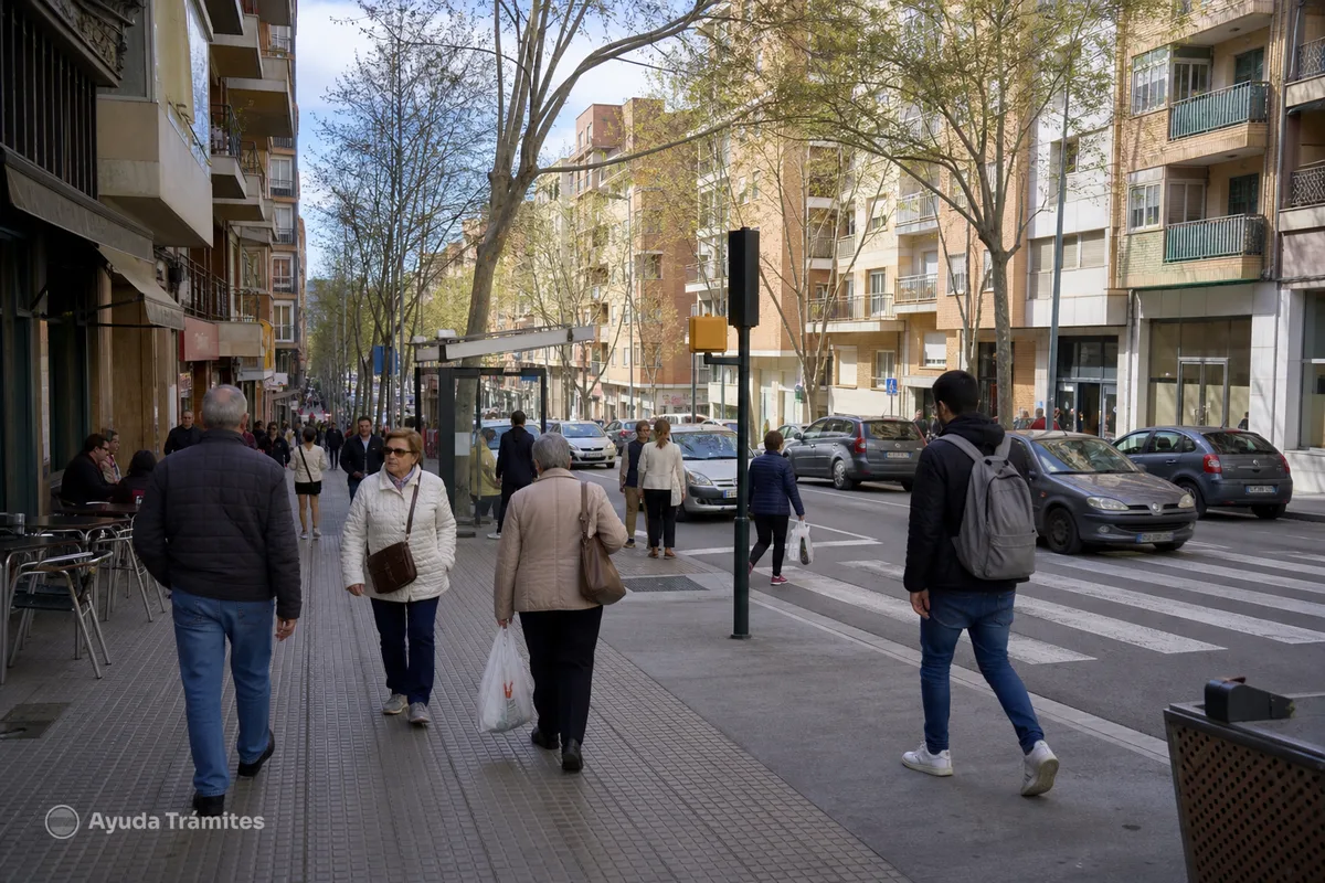 People walking through a residential street in Spain.