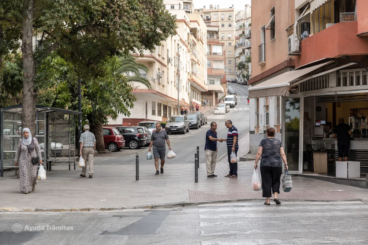 People walking through an urban street in Ceuta.